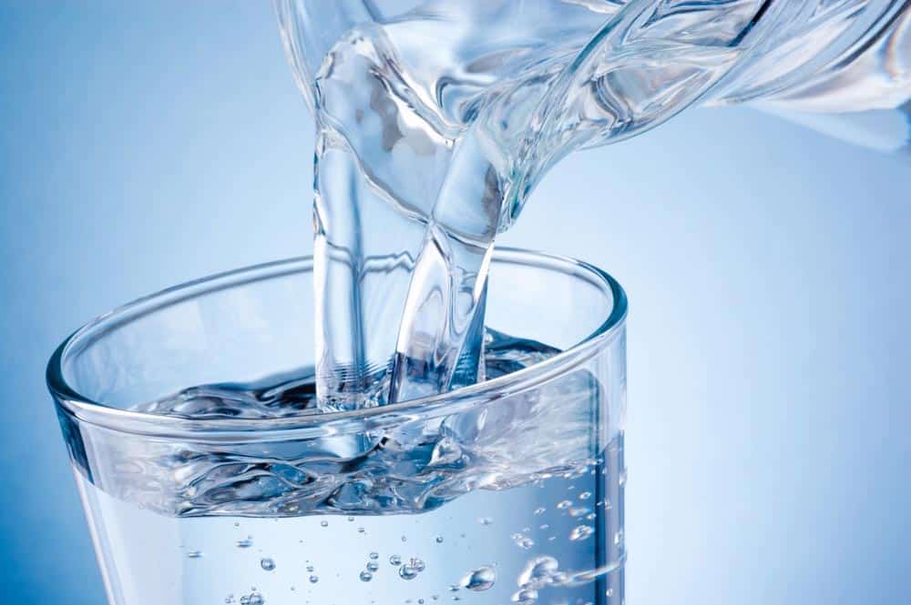 Spring Water Being Poured To A Glass