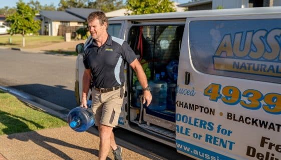 Man Carrying A Gallon Of Spring Water — Spring Water Online in Agnes Water, QLD