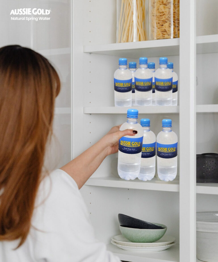 Woman Getting Bottled Spring Water