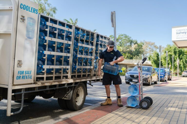 Truck With Spring Water On Containers For Delivery