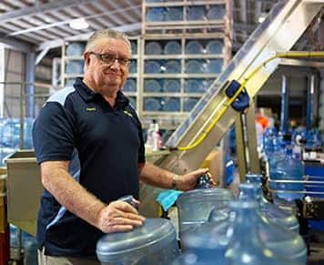 Owner holding water bottle — Spring Water Supplier in Yeppoon, QLD