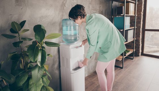 Woman Refilling Glass of Water — Spring Water Online in Mackay, QLD
