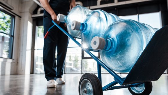 Pushing Trolley of Water Bottles — Spring Water Online in Mackay, QLD
