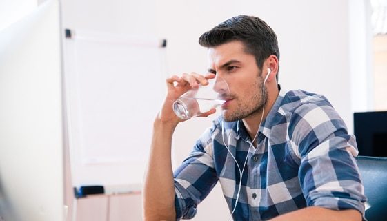 Man Drinking Water While Listening To Music — Spring Water Online in Isaac, QLD