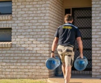 Man Carrying Two Gallons of Spring Water — Spring Water Online in Capella, QLD