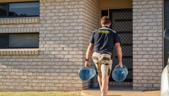 Man Carrying Two Gallons of Spring Water — Spring Water Online in Capella, QLD