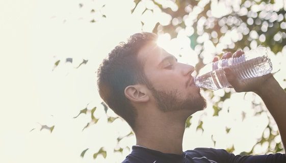 Man Drinking Water During Hot Weather — Spring Water Online in Isaac, QLD