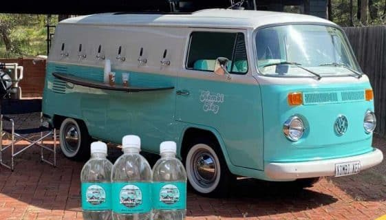 Spring Water On A Branded Bottle With Truck In The Background — Spring Water Online in Tieri, QLD