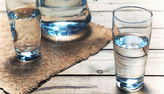 Glasses Of Water On Wooden Table — Spring Water Online in Emerald, QLD