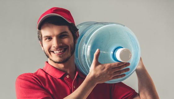 Delivery Worker Holding A Gallon Of Water — Spring Water Online in Blackwater, QLD