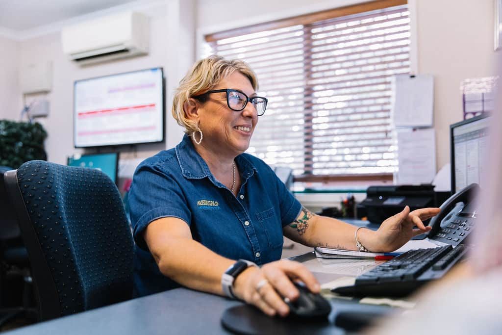 Women Smiling at Computer — Spring Water Online in Emerald, QLD