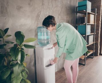 Woman Taking Water From A Dispenser