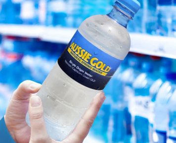 Hands Holding Bottled Spring Water
