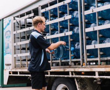 Man Loading Water Gallons for Delivery