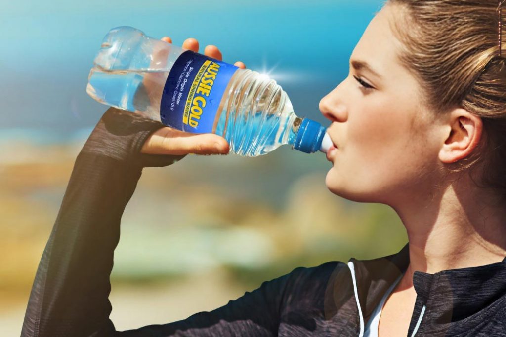 Woman Drinking Bottled Spring Water From Aussie Gold